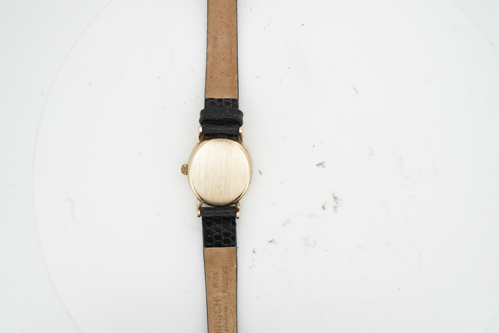 A lady's recent 9ct gold Rotary quartz wrist watch, with oval Roman dial, case diameter 18mm, on an associated leather strap, no box or papers.